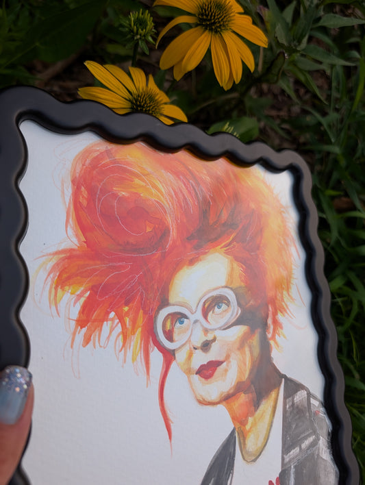 Original mixed media portrait of Vivienne Westwood with orange red hair white glasses and Get a Life Foundation shirt in black wavy frame