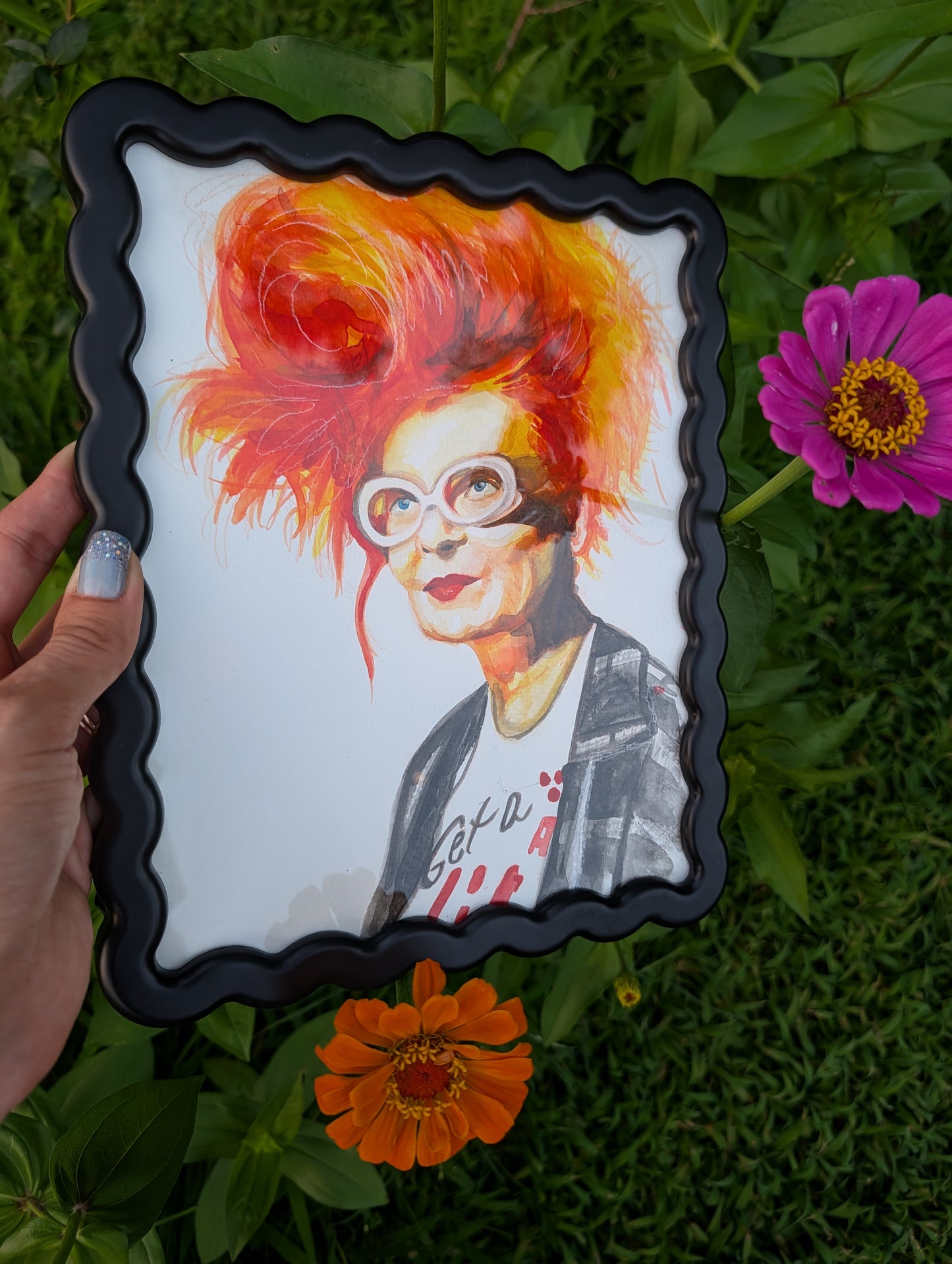Original mixed media portrait of Vivienne Westwood with orange red hair white glasses and Get a Life Foundation shirt in black wavy frame