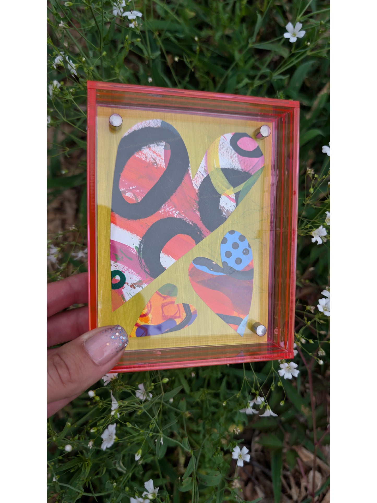 Small original heart collage with black pink and orange hand-painted paper hearts on lime green background floating in neon pink acrylic frame