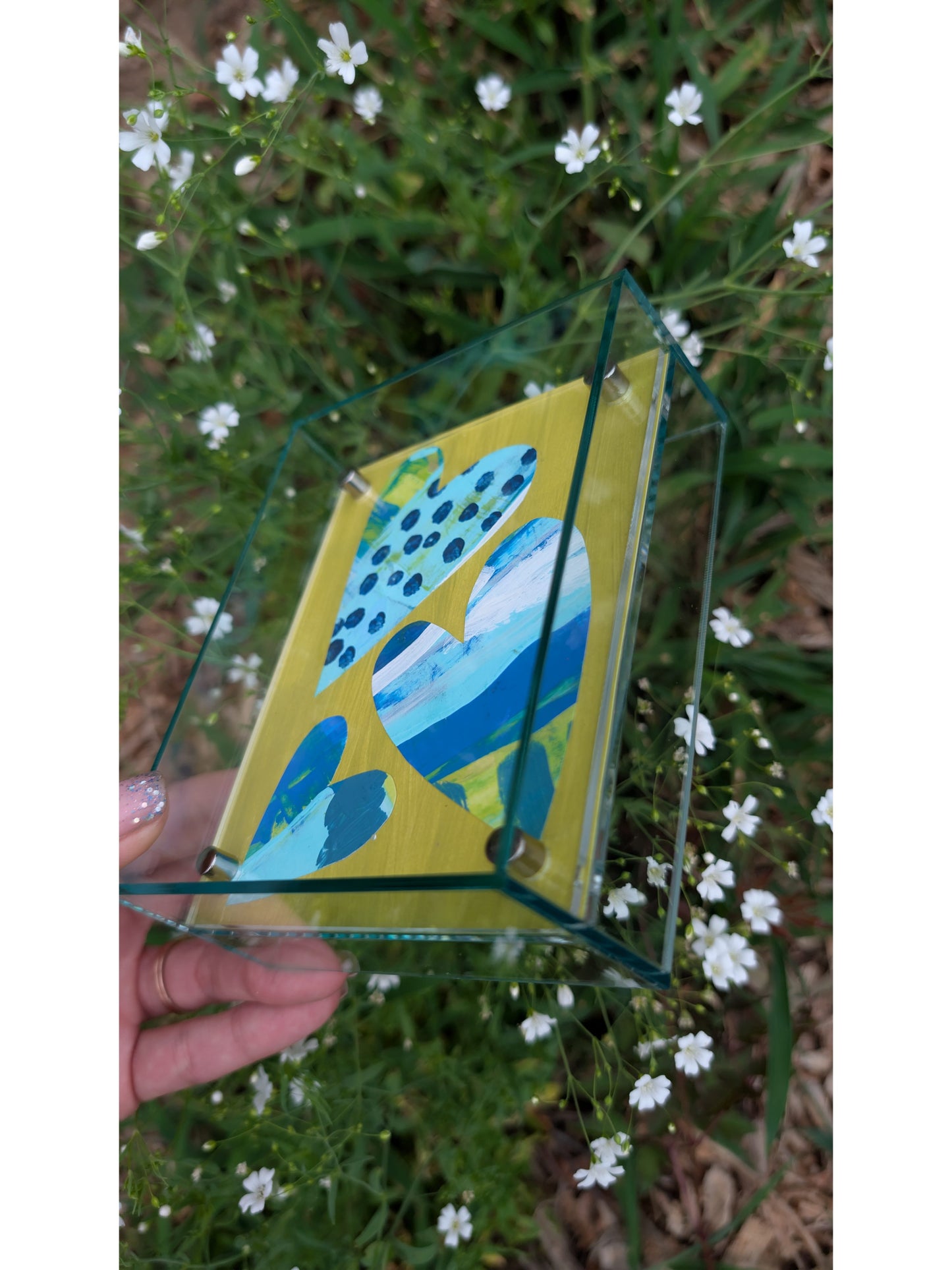 Small original heart collage with blue turquoise and white hand-painted paper hearts on lime green background in soft green acrylic float frame