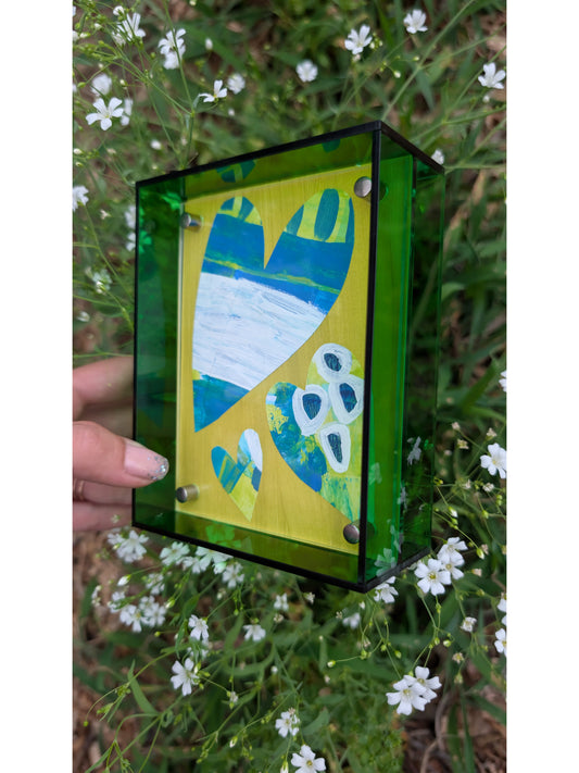 Small original heart collage with blue green and white hand-painted paper hearts on lime green background in bright green acrylic float frame