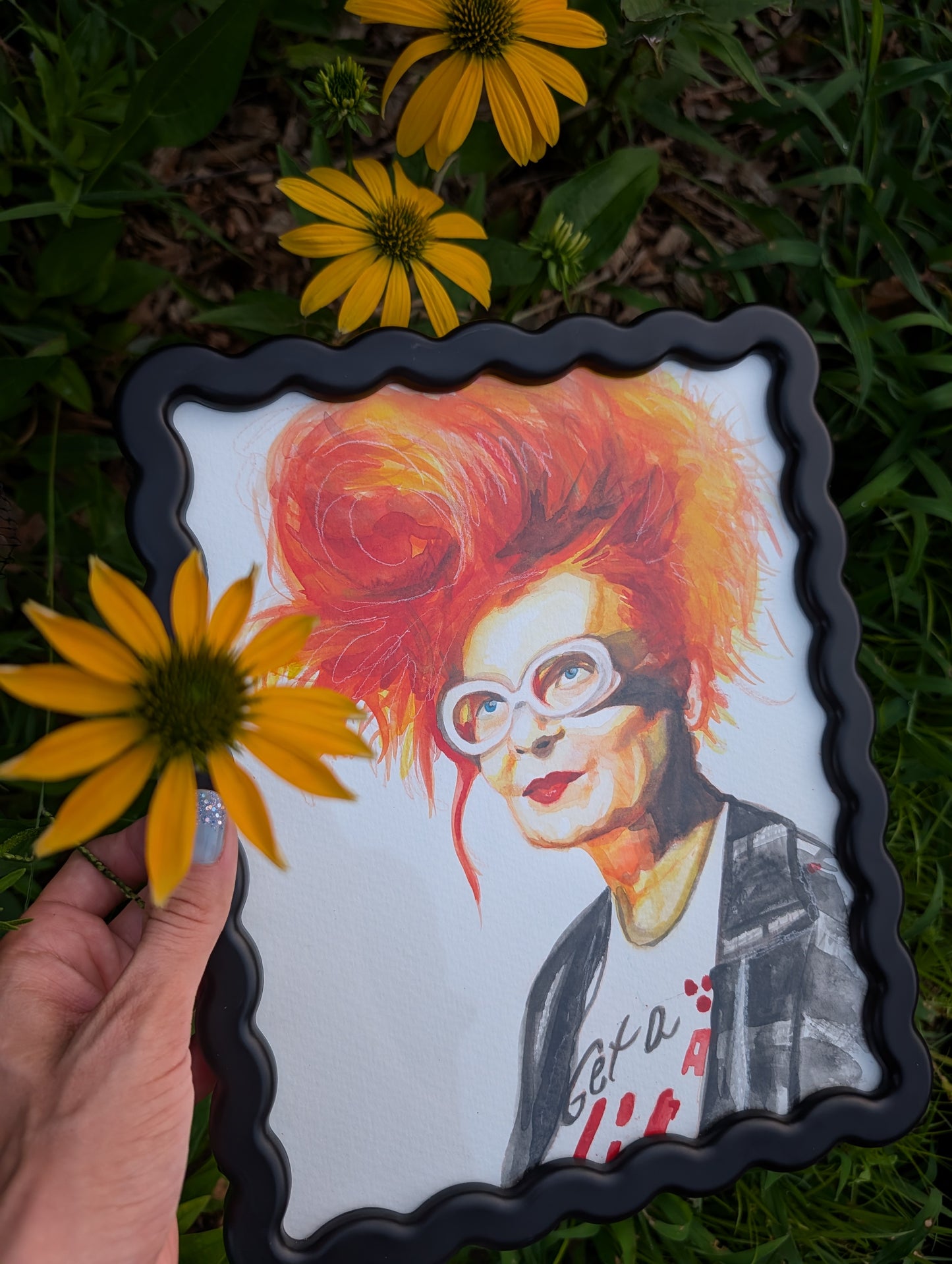 Original mixed media portrait of Vivienne Westwood with orange red hair white glasses and Get a Life Foundation shirt in black wavy frame