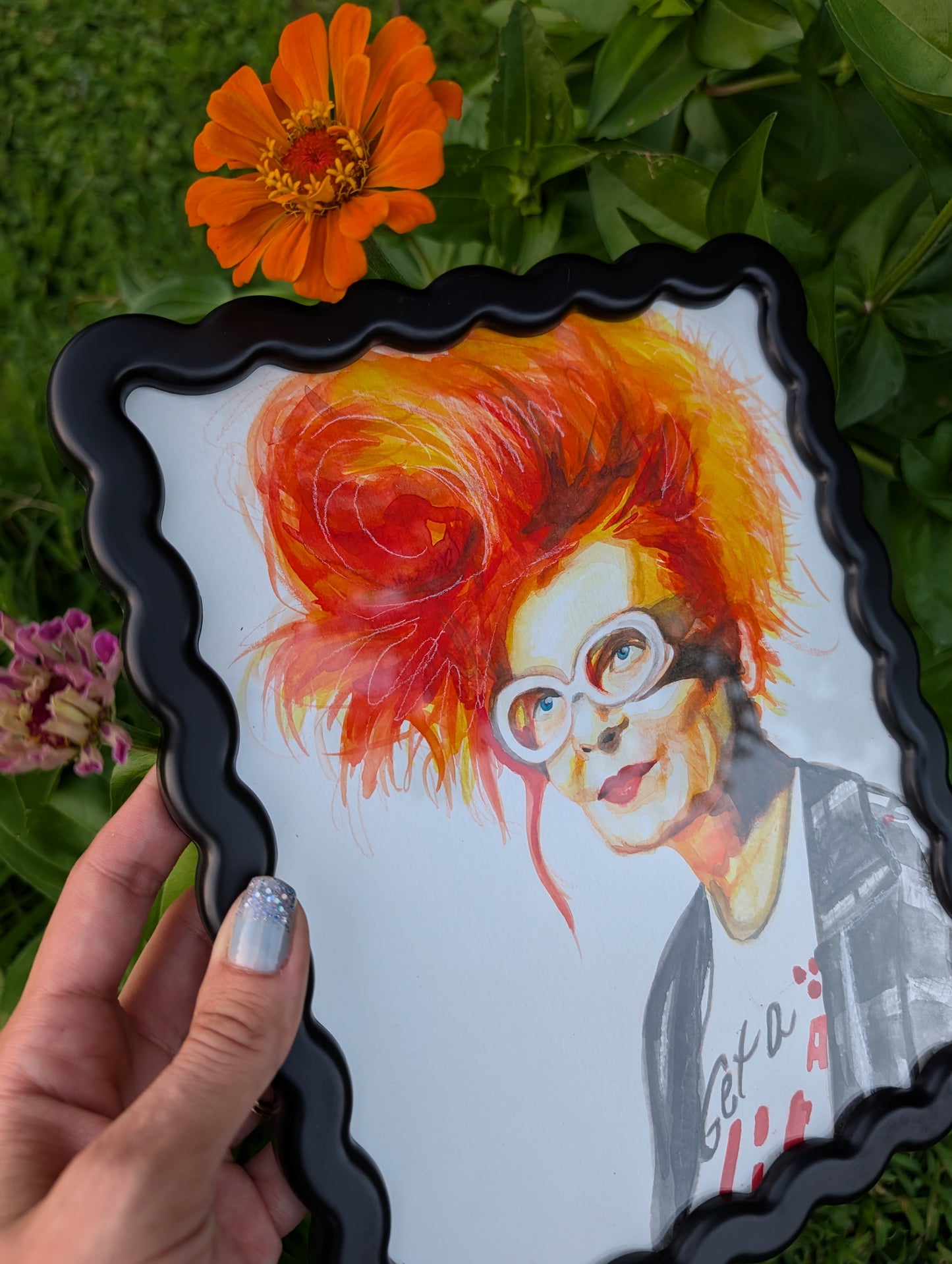 Original mixed media portrait of Vivienne Westwood with orange red hair white glasses and Get a Life Foundation shirt in black wavy frame