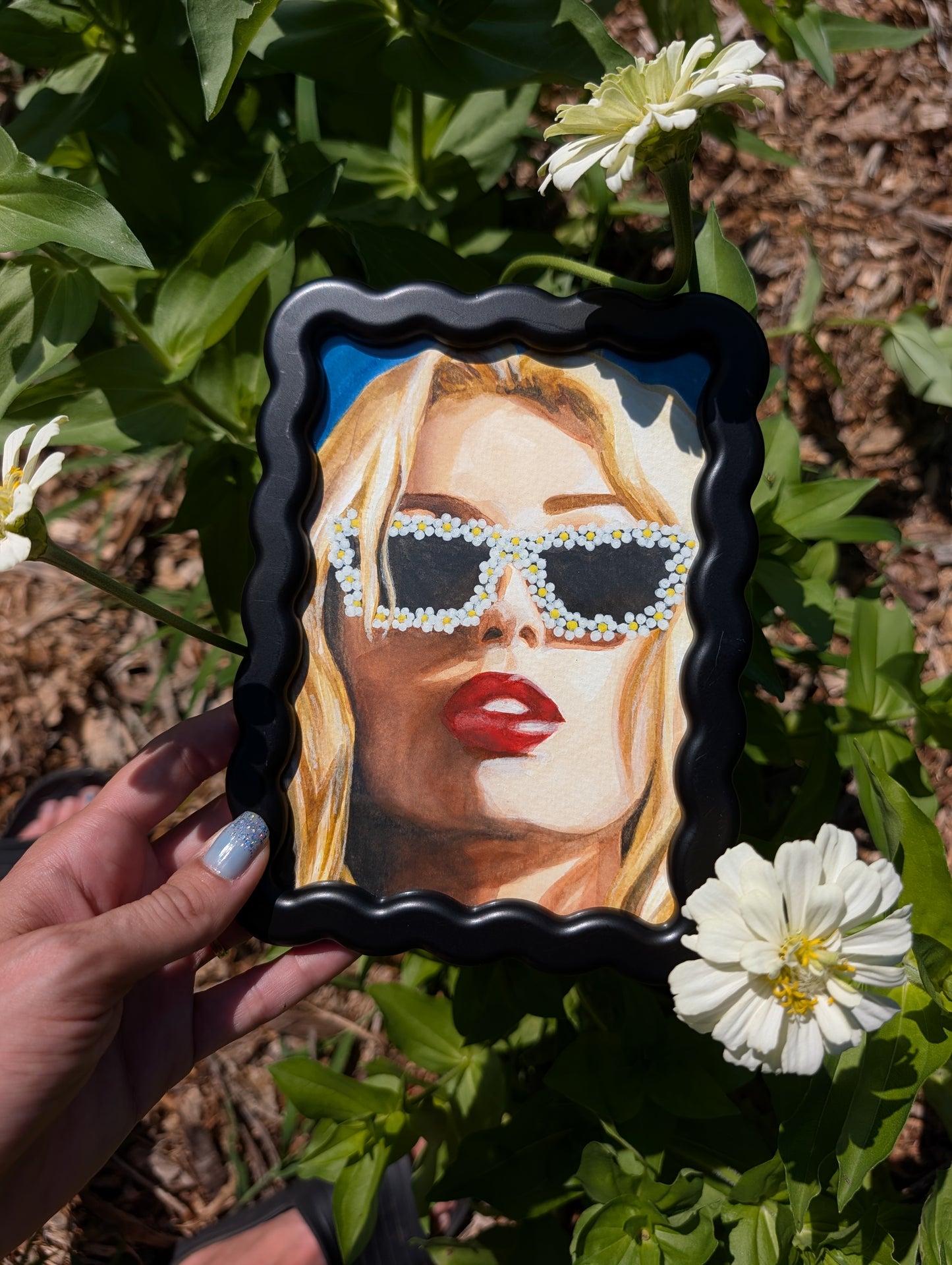 Original mixed media portrait with flower sunglasses and red lips on bright blue background in black wavy frame