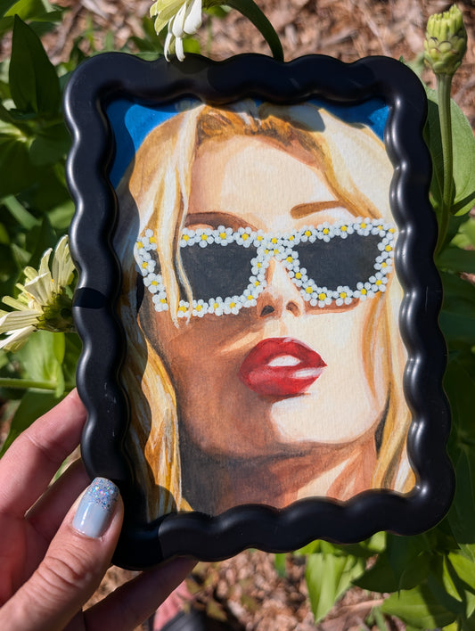 Original mixed media portrait with flower sunglasses and red lips on bright blue background in black wavy frame