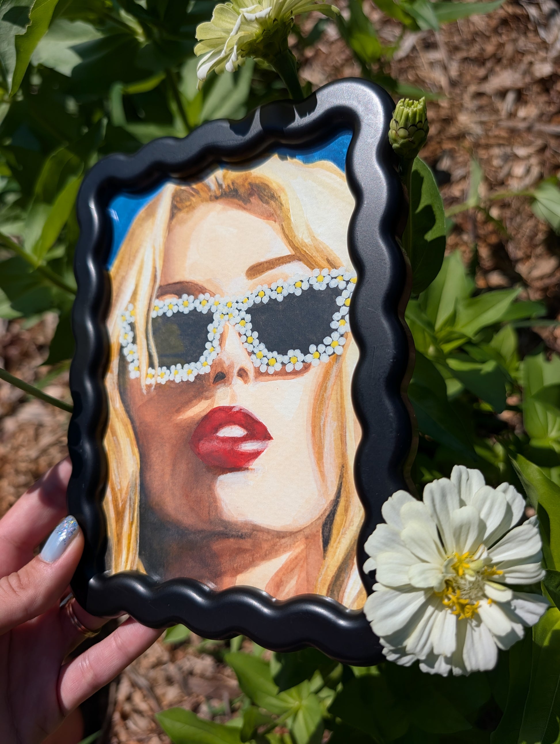 Original mixed media portrait with flower sunglasses and red lips on bright blue background in black wavy frame