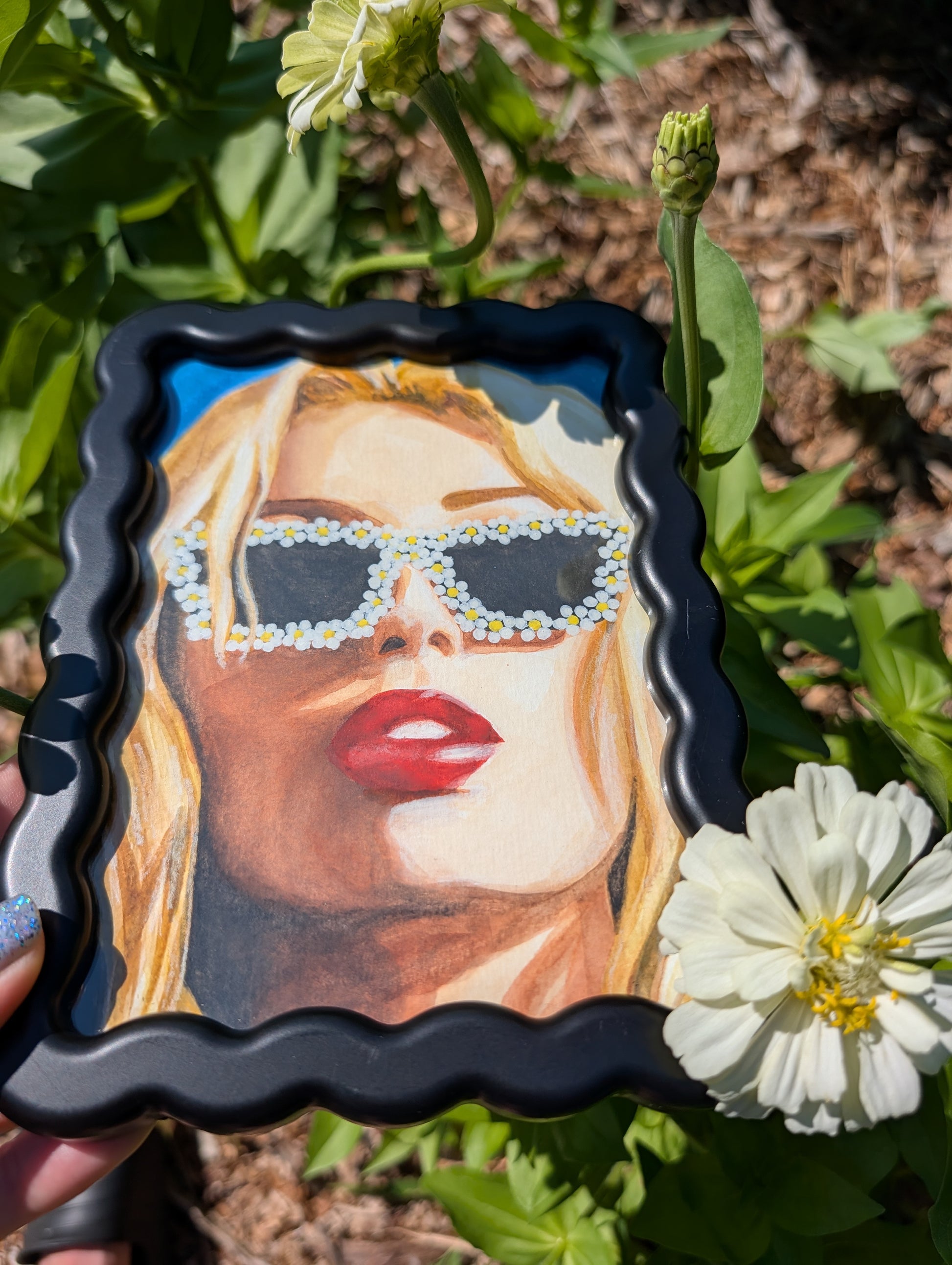 Original mixed media portrait with flower sunglasses and red lips on bright blue background in black wavy frame