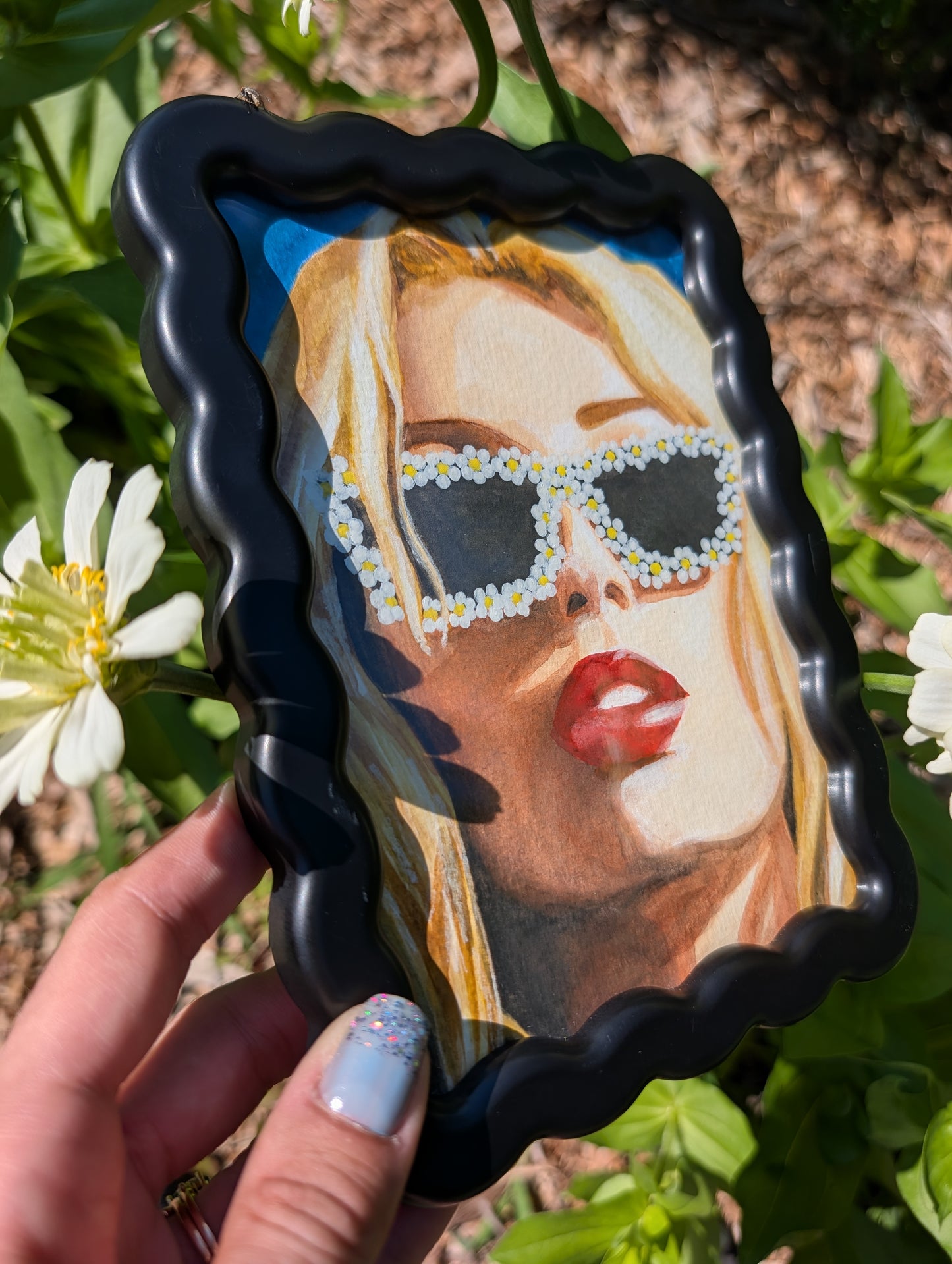 Original mixed media portrait with flower sunglasses and red lips on bright blue background in black wavy frame