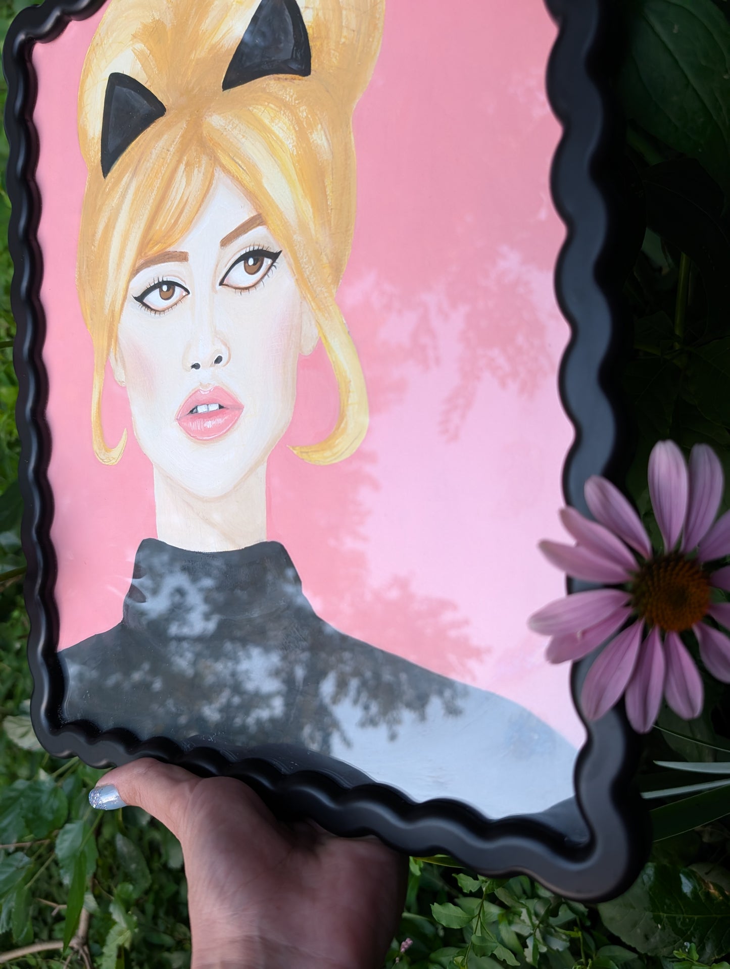 Original mixed media portrait of Brigitte Bardot with black cat ears and black turtleneck on pink background in black wavy frame