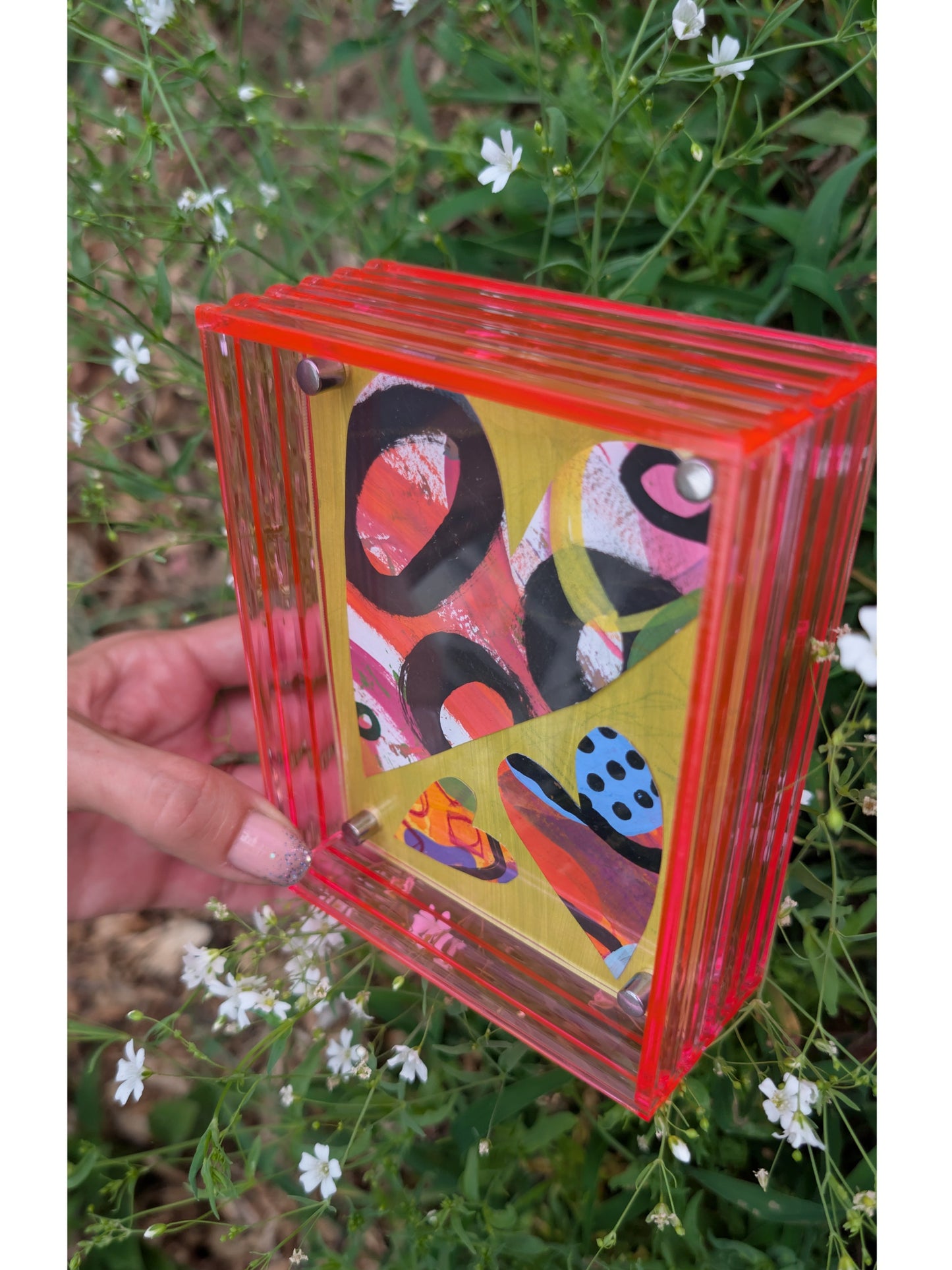 Small original heart collage with black pink and orange hand-painted paper hearts on lime green background floating in neon pink acrylic frame