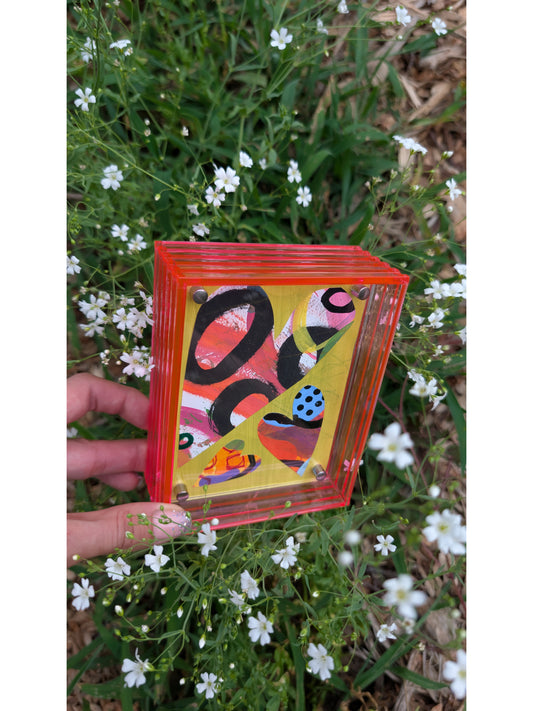 Small original heart collage with black pink and orange hand-painted paper hearts on lime green background floating in neon pink acrylic frame