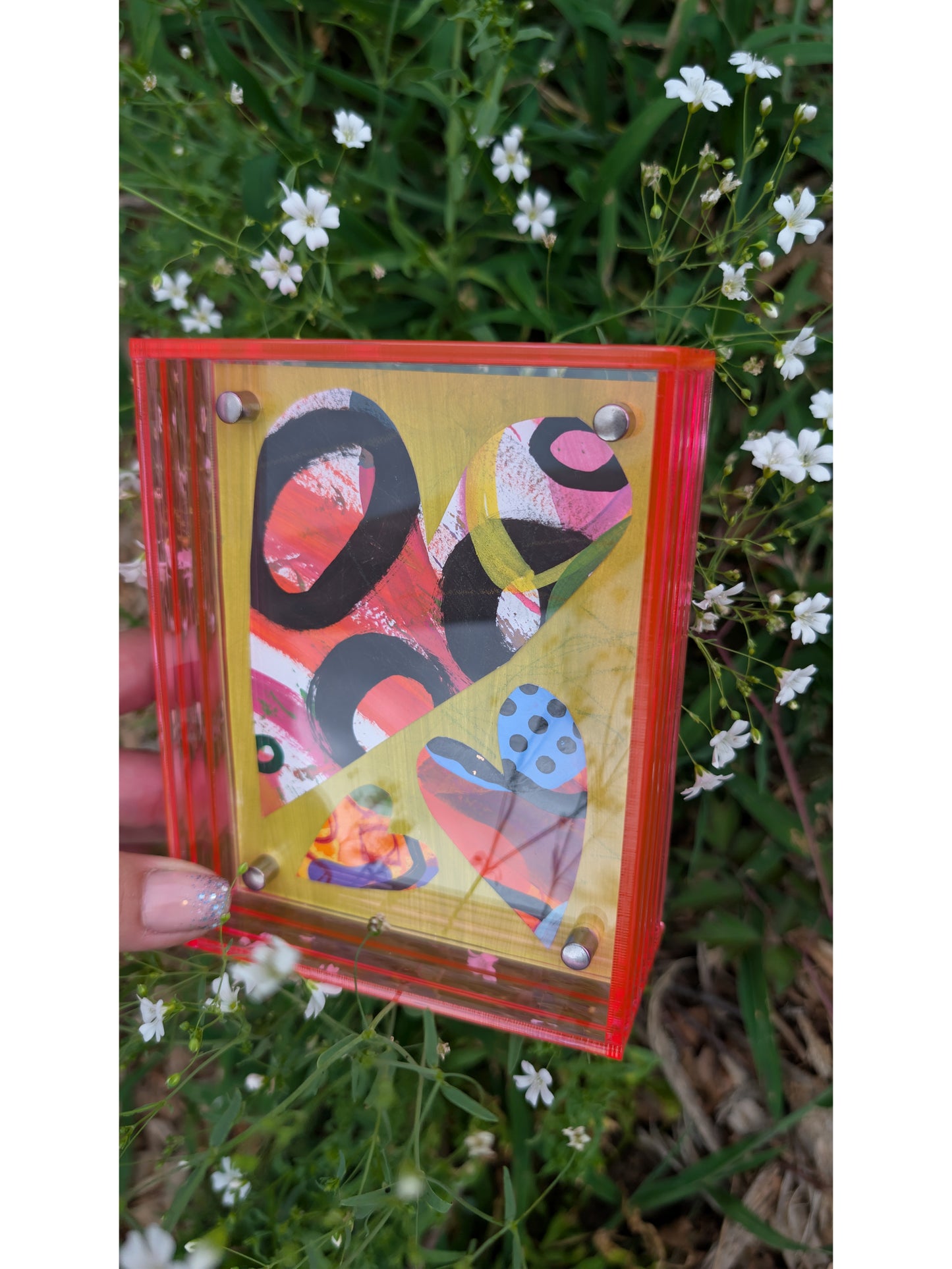 Small original heart collage with black pink and orange hand-painted paper hearts on lime green background floating in neon pink acrylic frame