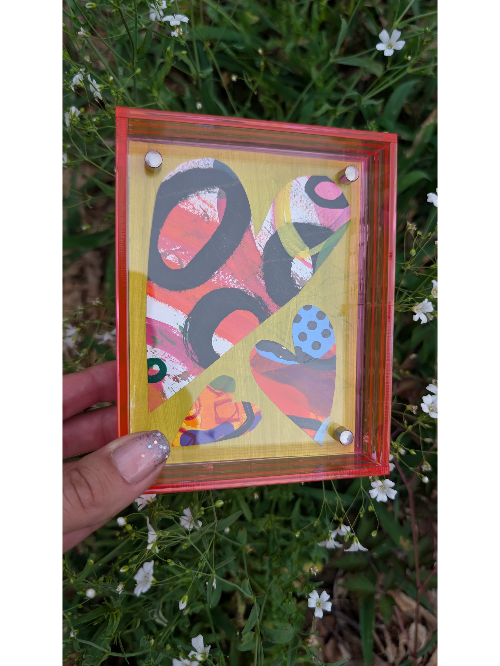 Small original heart collage with black pink and orange hand-painted paper hearts on lime green background floating in neon pink acrylic frame