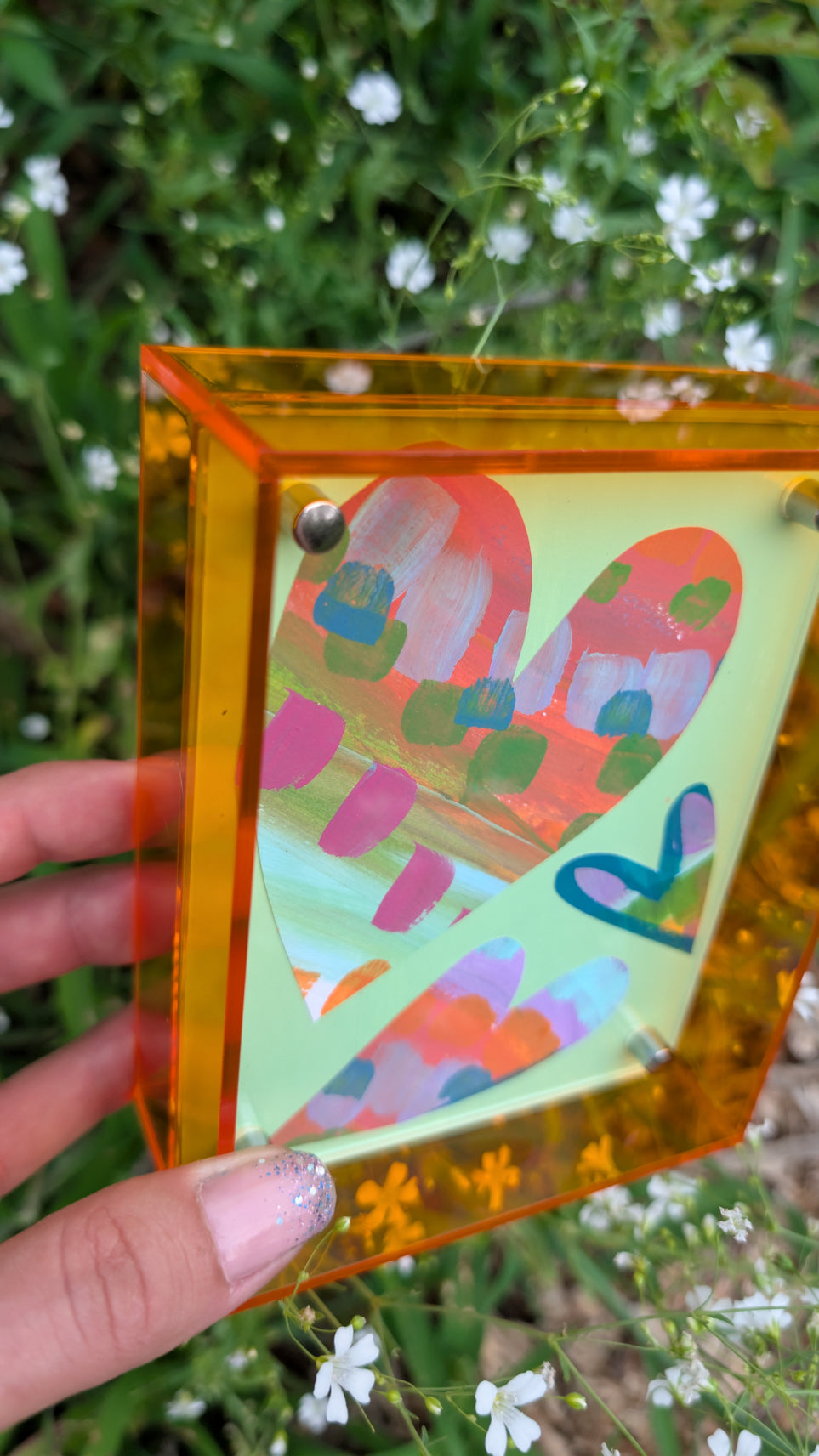 Small original heart collage with green pink and orange hand-painted paper hearts on mint green background in neon orange acrylic float frame
