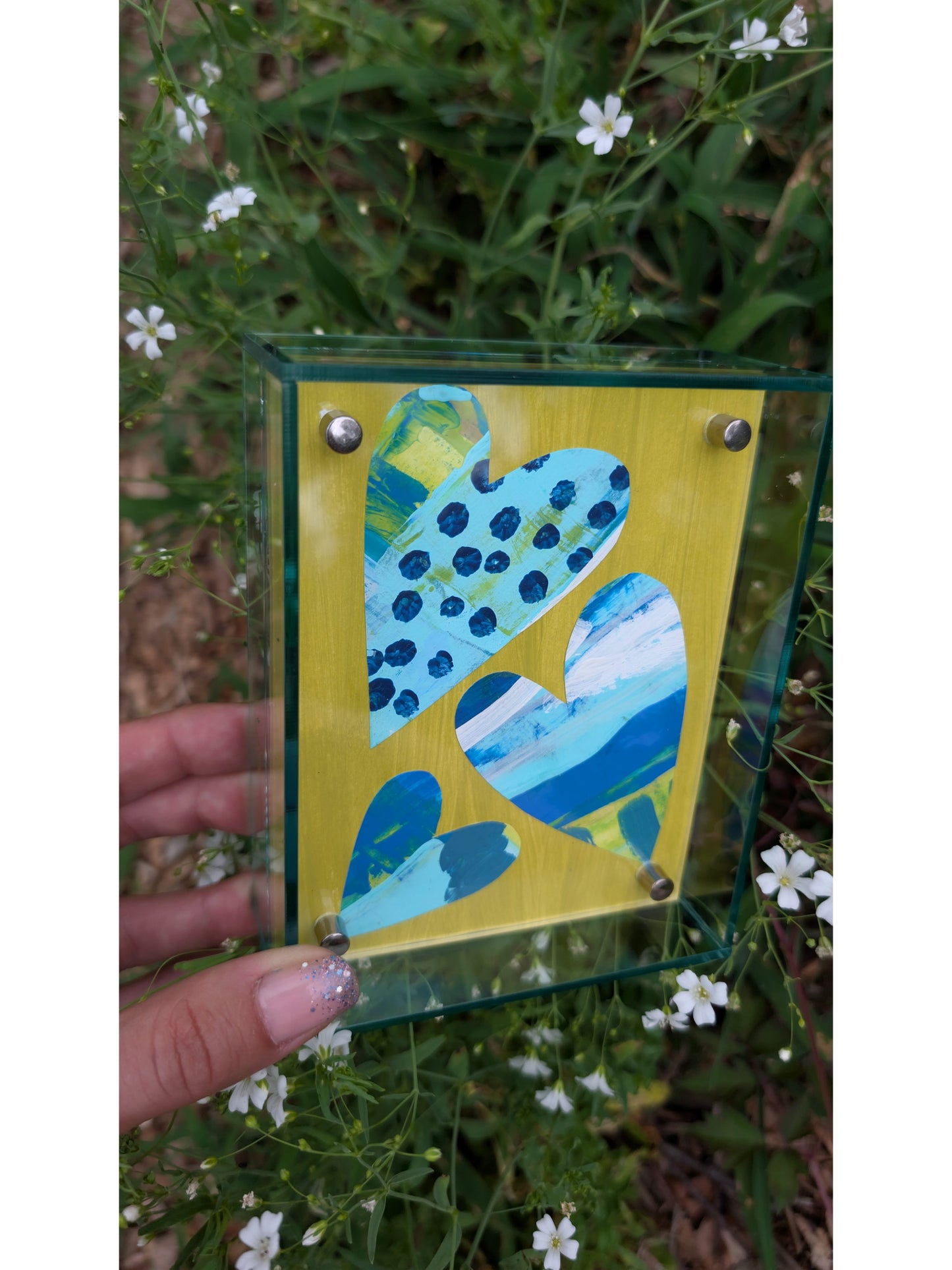 Small original heart collage with blue turquoise and white hand-painted paper hearts on lime green background in soft green acrylic float frame