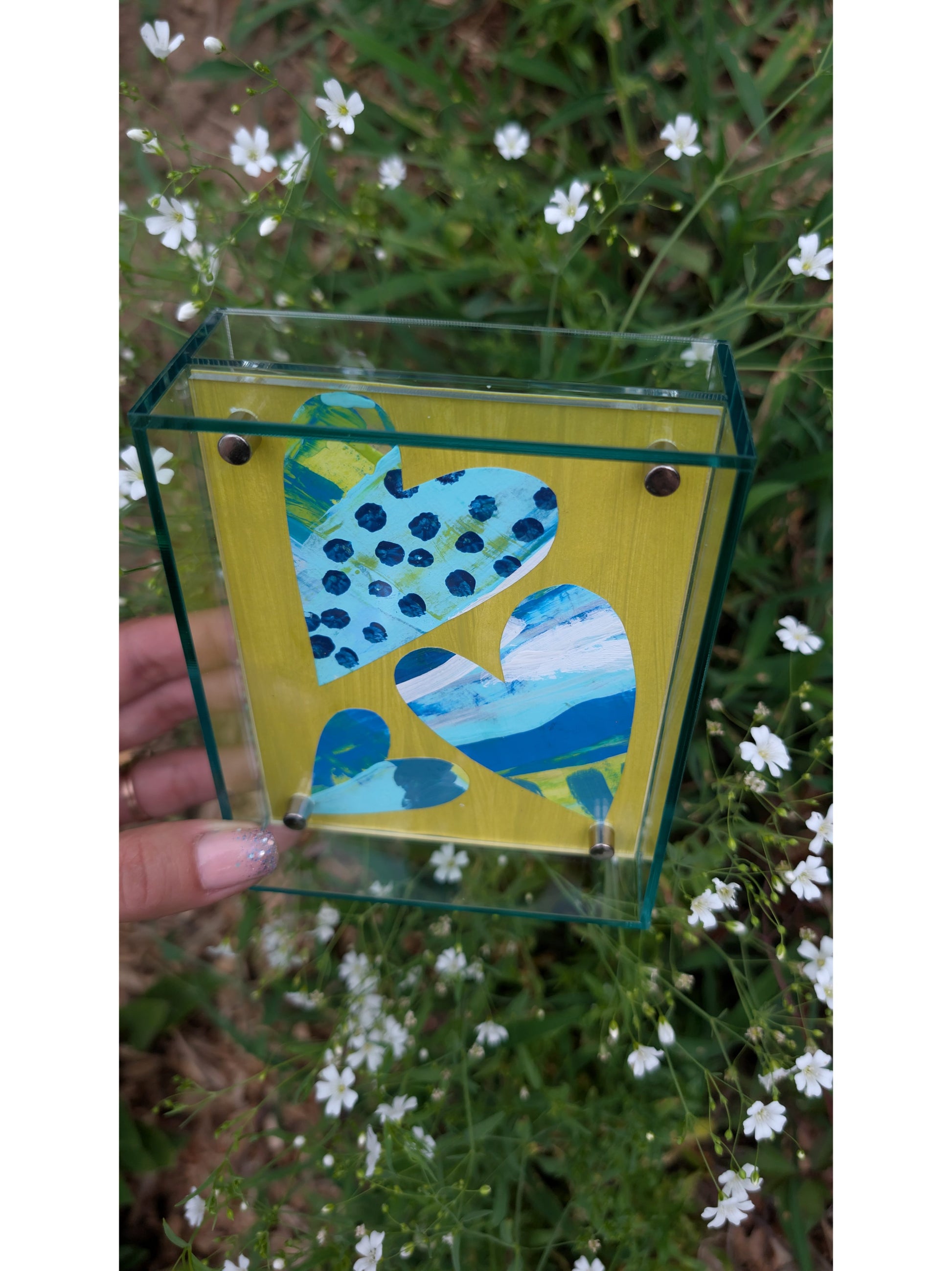 Small original heart collage with blue turquoise and white hand-painted paper hearts on lime green background in soft green acrylic float frame