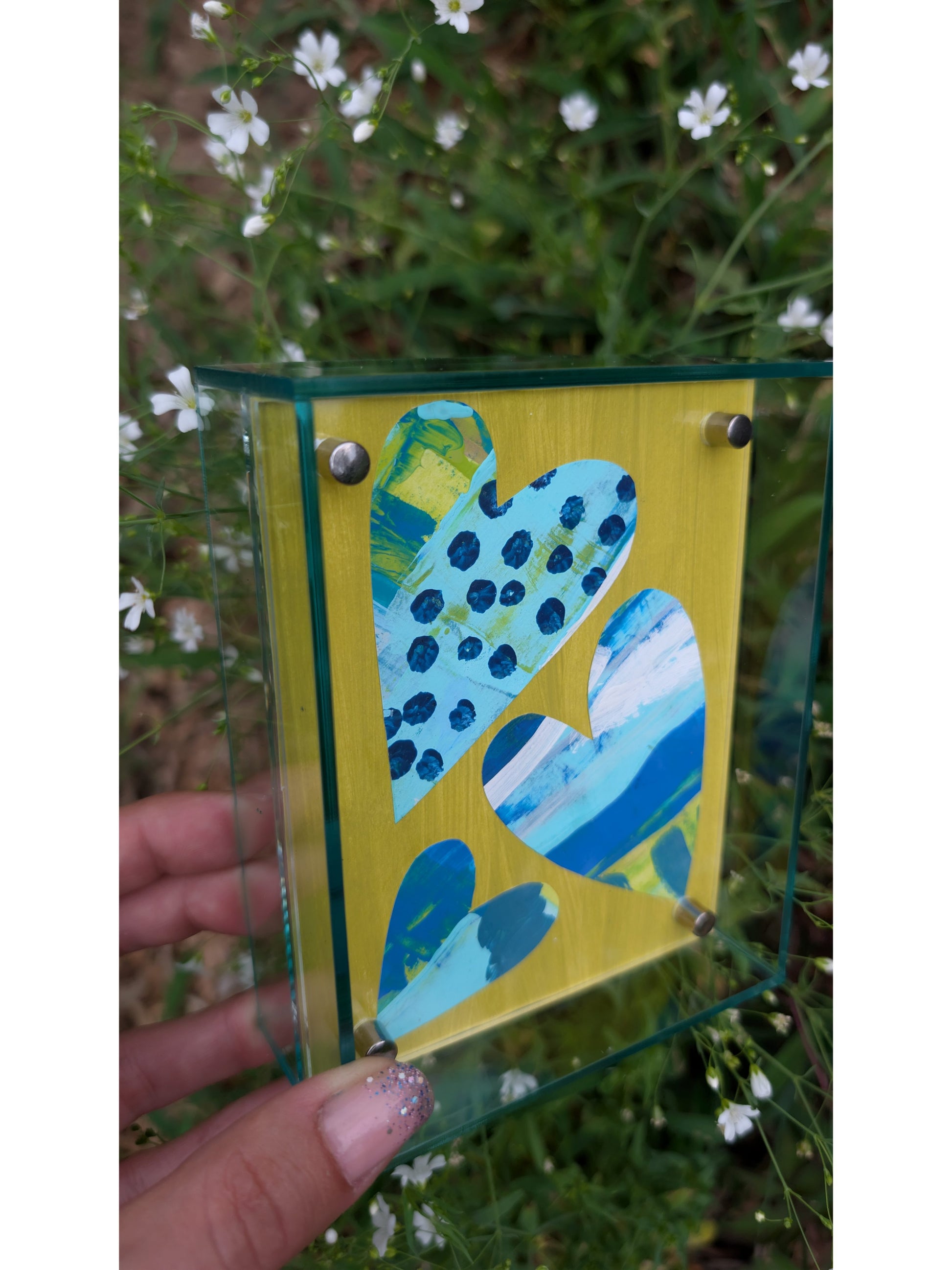 Small original heart collage with blue turquoise and white hand-painted paper hearts on lime green background in soft green acrylic float frame