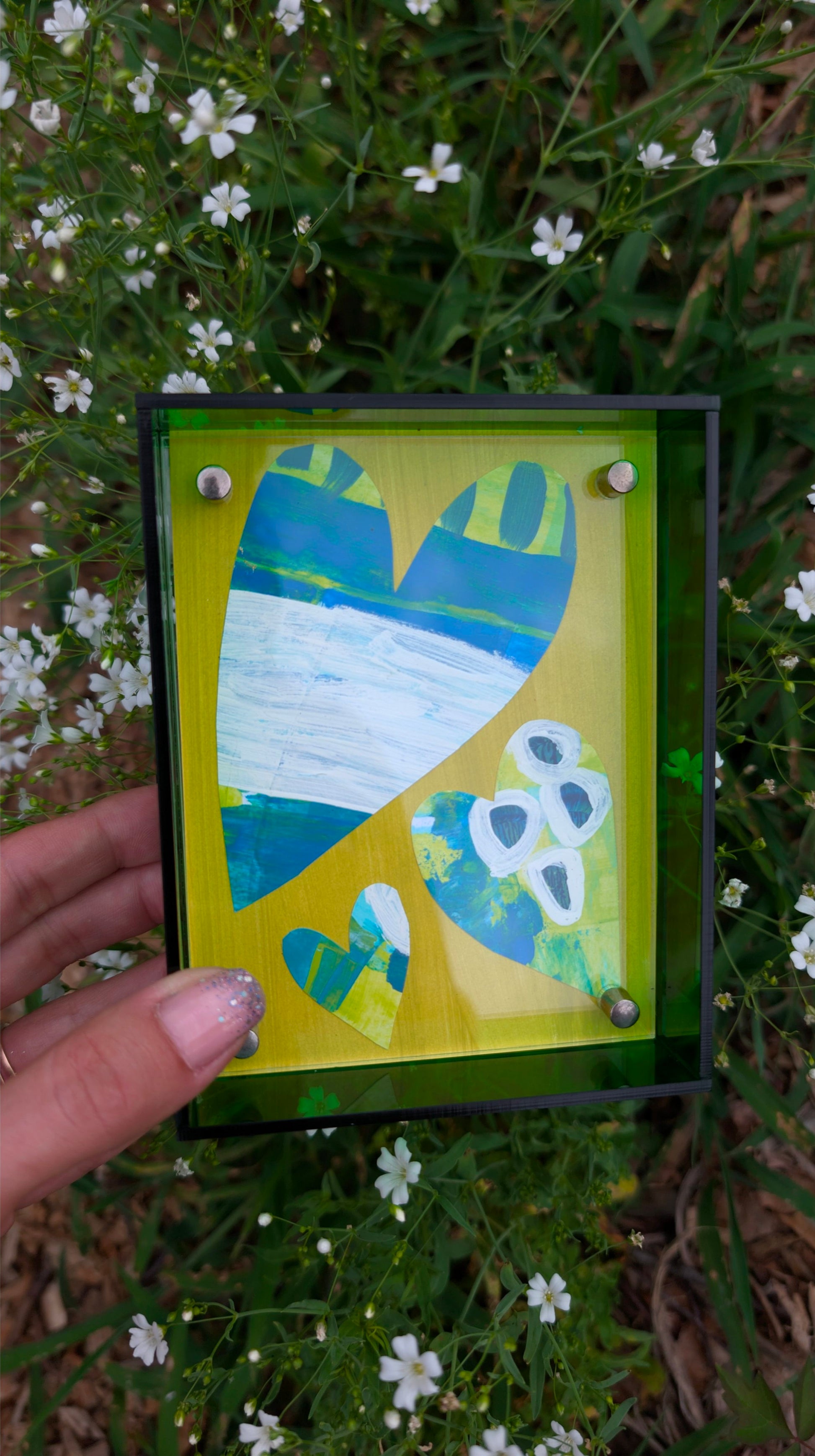 Small original heart collage with blue green and white hand-painted paper hearts on lime green background in bright green acrylic float frame