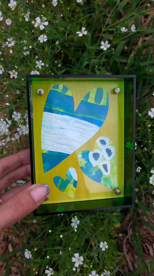 Small original heart collage with blue green and white hand-painted paper hearts on lime green background in bright green acrylic float frame