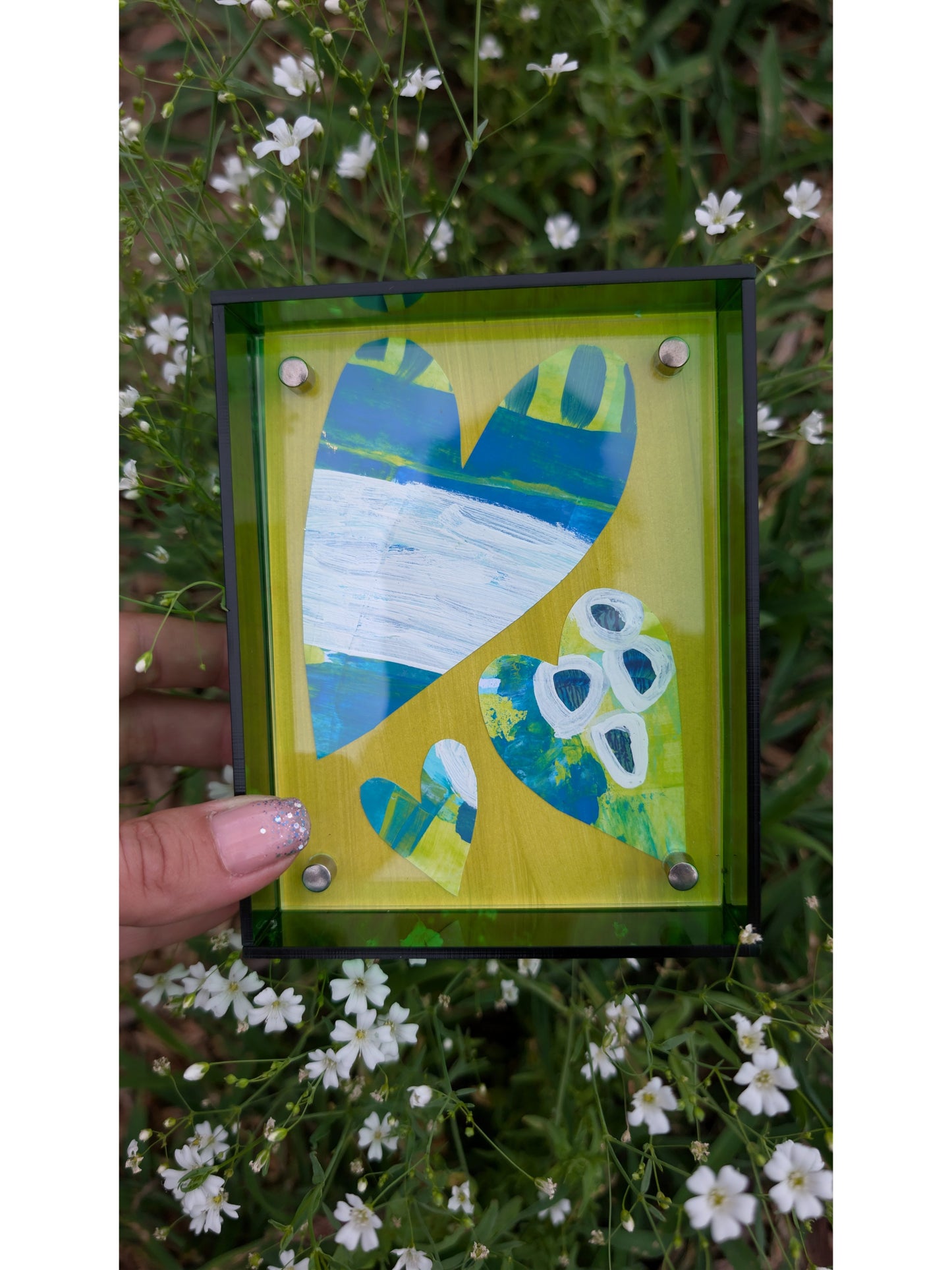 Small original heart collage with blue green and white hand-painted paper hearts on lime green background in bright green acrylic float frame