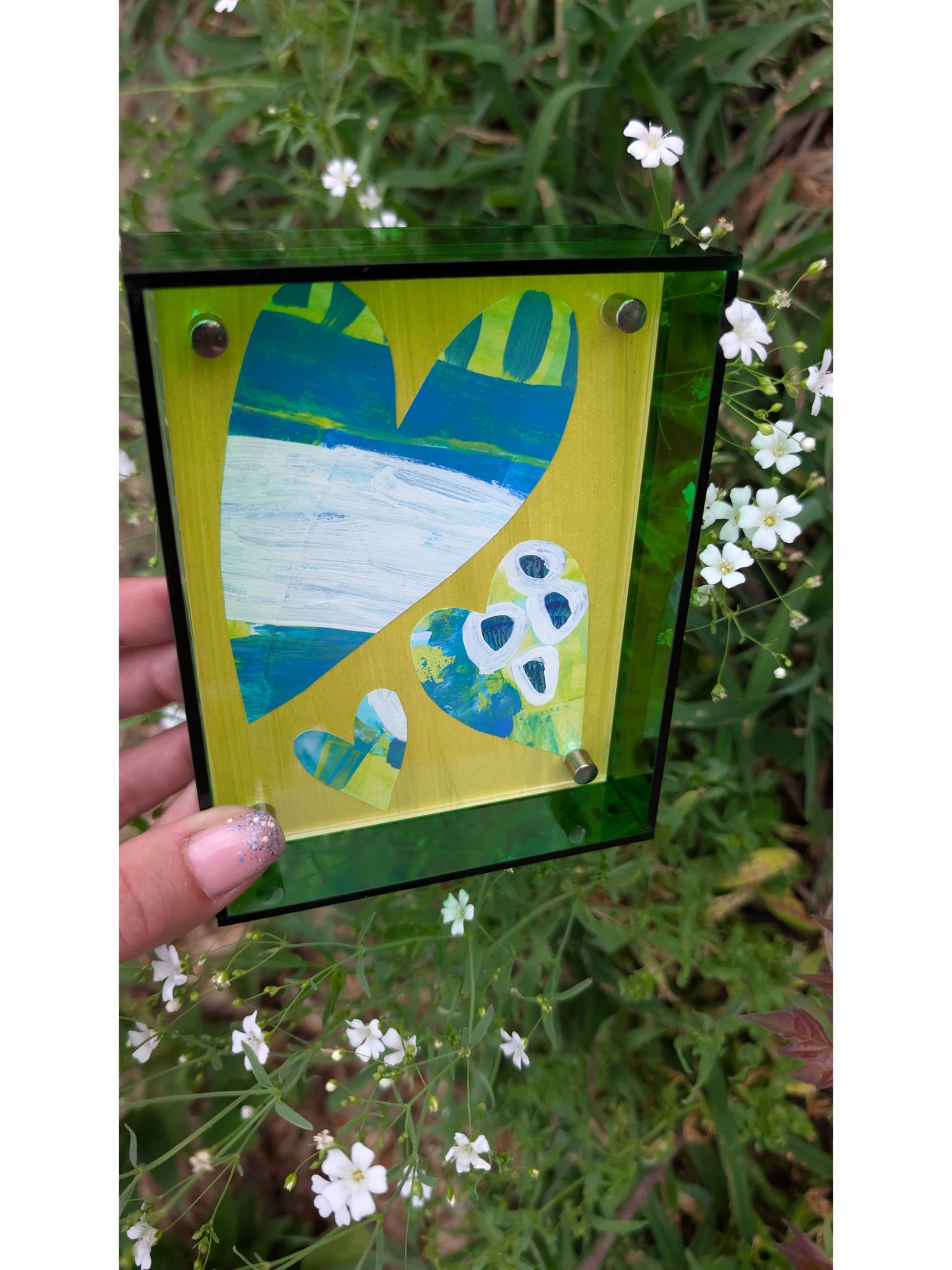 Small original heart collage with blue green and white hand-painted paper hearts on lime green background in bright green acrylic float frame