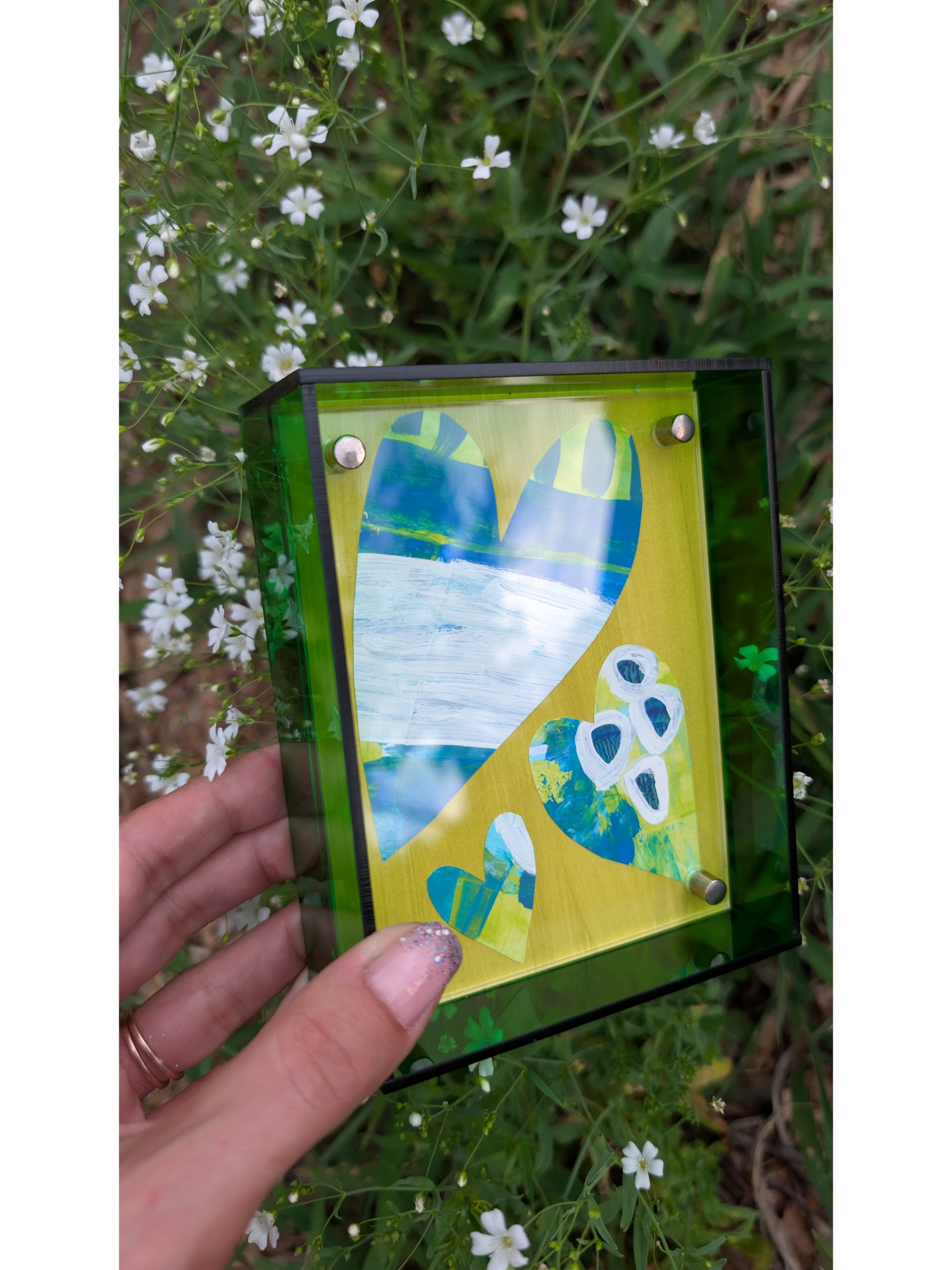 Small original heart collage with blue green and white hand-painted paper hearts on lime green background in bright green acrylic float frame