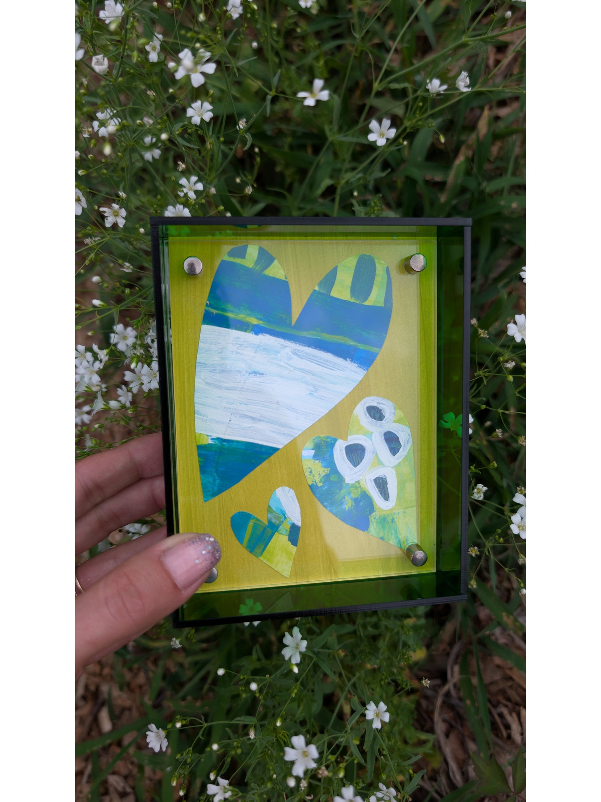 Small original heart collage with blue green and white hand-painted paper hearts on lime green background in bright green acrylic float frame