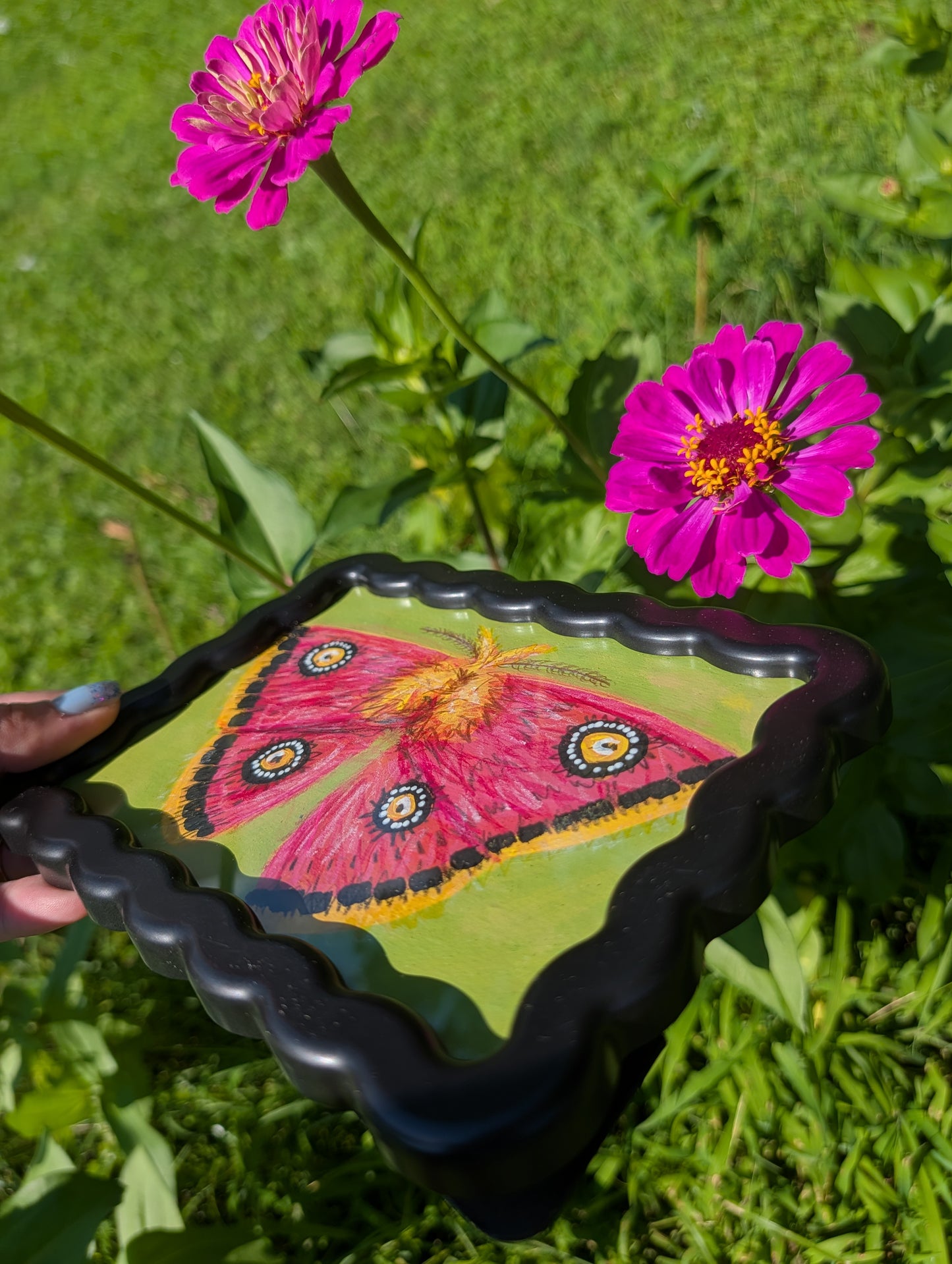 Original mixed media painting of pink moth with bold black white and yellow markings on lime green background in black wavy frame