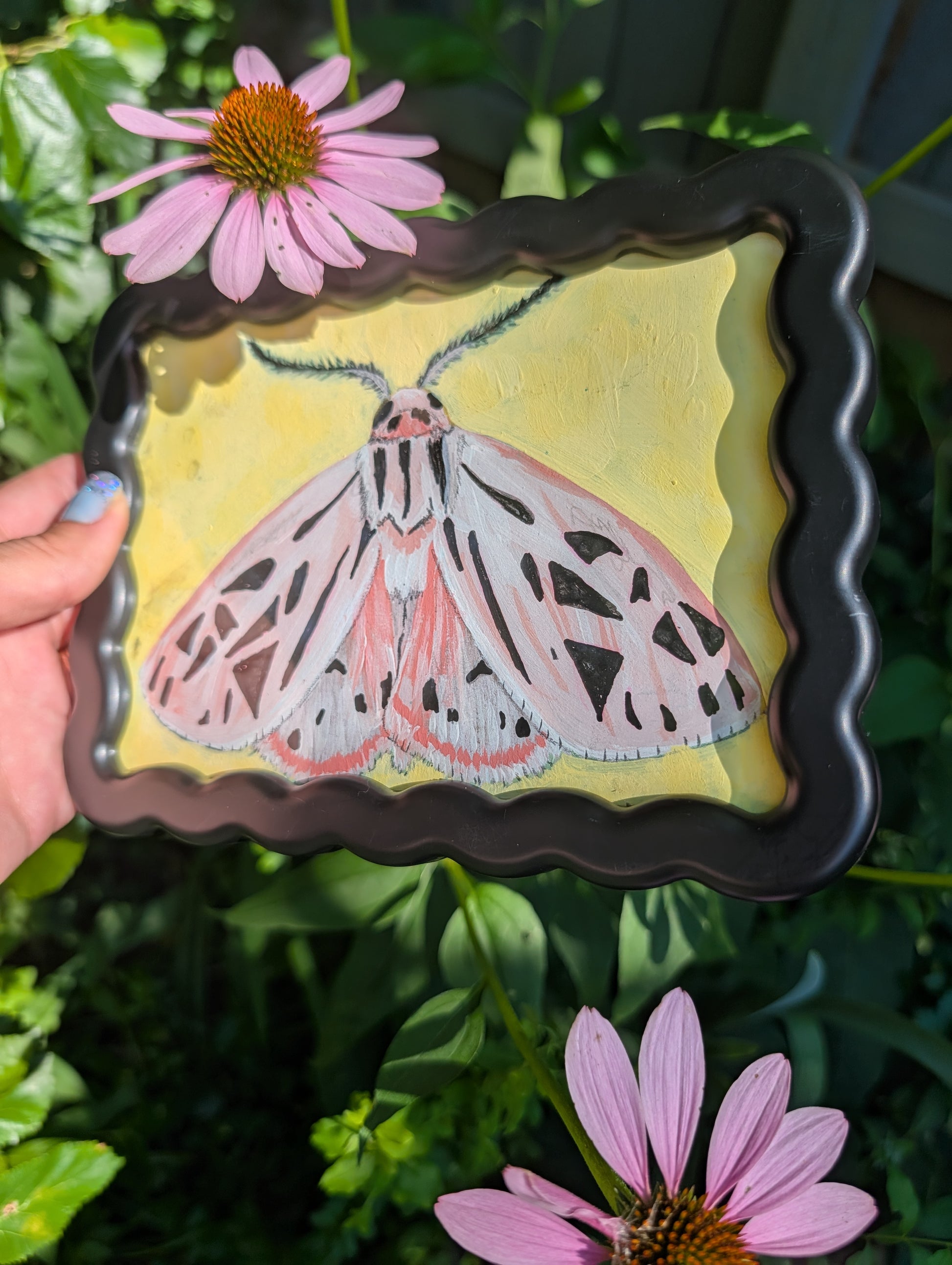 Original mixed media painting of pink moth with delicate black markings and fluffy antennae on soft yellow background in black wavy frame