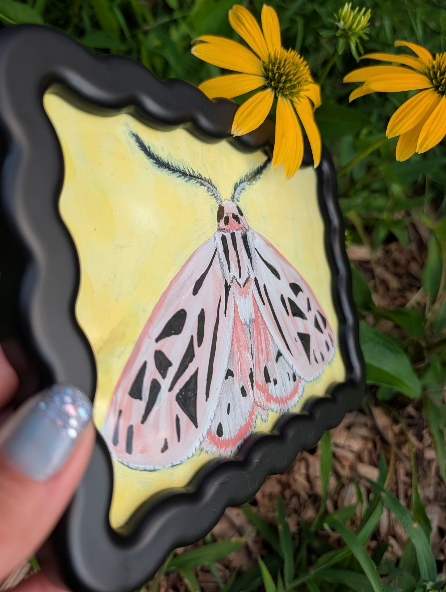Original mixed media painting of pink moth with delicate black markings and fluffy antennae on soft yellow background in black wavy frame